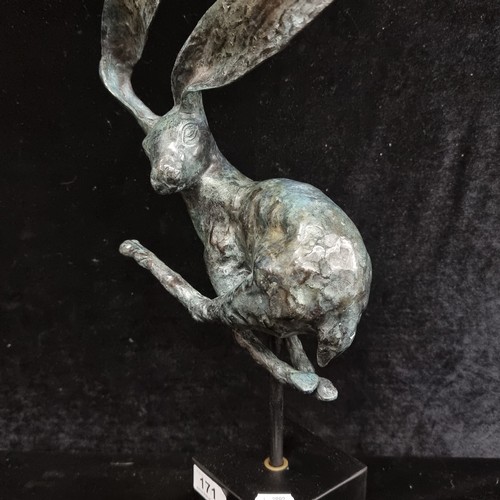 171 - Star Lot: A large Intricate heavy bronze sculpture depicting a whimsical hare in mid-leap, showcasin... 