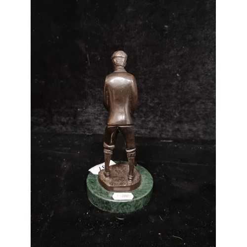 197 - A handcrafted heavy bronze figure of a male golfer mounted on a green marble plinth base.