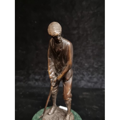 197 - A handcrafted heavy bronze figure of a male golfer mounted on a green marble plinth base.