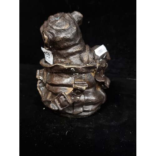 198 - Star Lot : A heavy brass sculptural piece of a dog poking out of a bag.