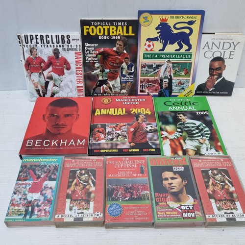 342 - A large box containing a selection of vintage football books, annuals and HVS tapes, related to Manc... 