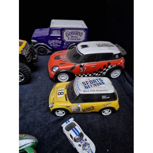 423 - Eleven toy vehicles including a Mini Cooper, Vespa motorcycle and Cadburys advertising van.