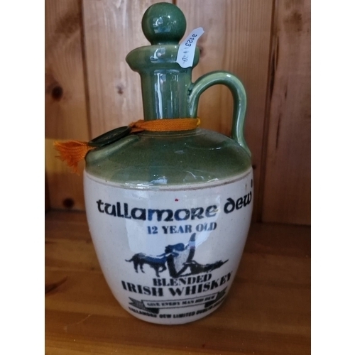 665 - Vintage collection of Irish whiskey jugs and glass bottles, including a ceramic Tullamore Dew 12-Yea... 