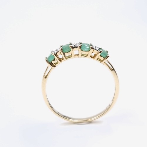 4 - Star Lot : A lovely diamond and emerald ring set in nine carat gold. Weight -1.17 grams. Size - P.