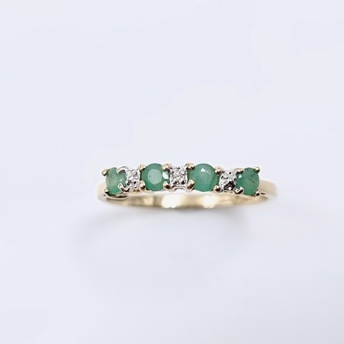 4 - Star Lot : A lovely diamond and emerald ring set in nine carat gold. Weight -1.17 grams. Size - P.