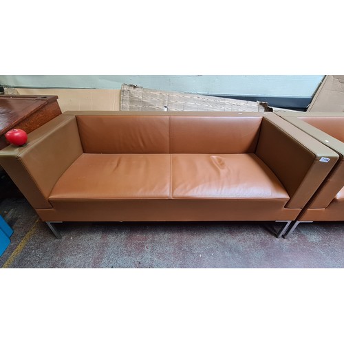 1194 - Star lot :A Pair of modern tan leather sofas with sleek metal legs. Minimalist design.