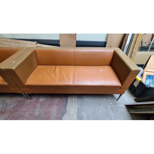 1194 - Star lot :A Pair of modern tan leather sofas with sleek metal legs. Minimalist design.