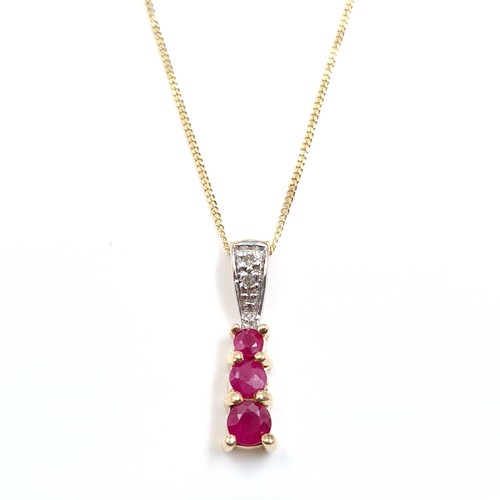 9 - Star Lot : A nine carat gold diamond and ruby pendant necklace & chain. Length of chain - 40 cms. We... 