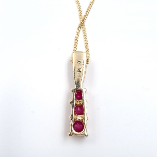 9 - Star Lot : A nine carat gold diamond and ruby pendant necklace & chain. Length of chain - 40 cms. We... 