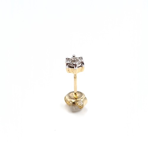 21 - Star Lot : A nine carat gold pair of diamond stud earrings. Weight - 0.91 grams.