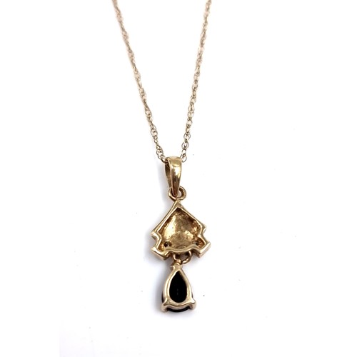 9 - A nine carat gold sapphire and diamond pendant necklace. Length of chain - 46cm. Weight - 1.3 grams.... 