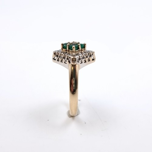 1 - Star Lot : An attractive nine carat gold mounted emerald and diamond ring. Size - J. Weight - 3.84 g... 