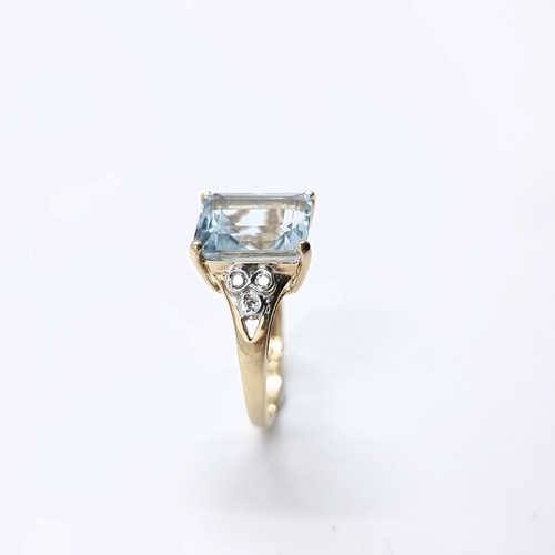 4 - Star Lot : A lovely nine carat gold large aquamarine stone ring with diamond set accents to shoulder... 