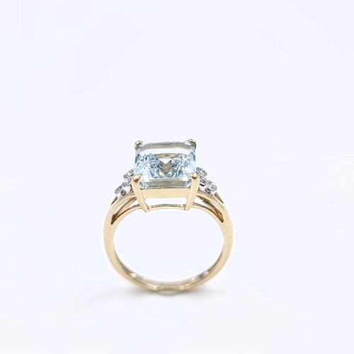 4 - Star Lot : A lovely nine carat gold large aquamarine stone ring with diamond set accents to shoulder... 