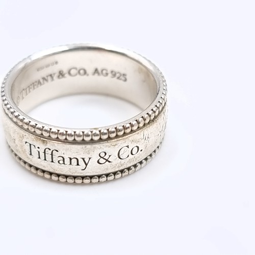 31 - A Tiffany & Co sterling silver ring. Marked AG925 with Tiffany & Co inscribed to inner and outer ban... 