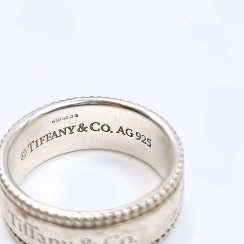 31 - A Tiffany & Co sterling silver ring. Marked AG925 with Tiffany & Co inscribed to inner and outer ban... 