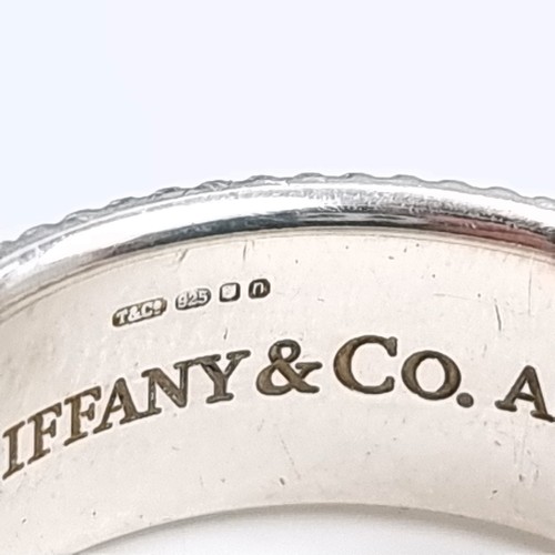 31 - A Tiffany & Co sterling silver ring. Marked AG925 with Tiffany & Co inscribed to inner and outer ban... 