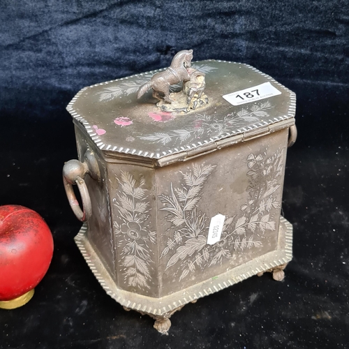 A beautiful pewter lidded box featuring ring handles to each side, a leaping horse finial and etched floral detail throughout.