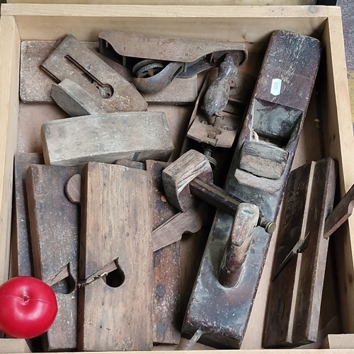 Antique wooden and metal woodworking planes, including moulding and bench planes.