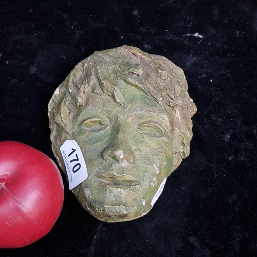 A hand sculpted ceramic plaque in the form of a mask of a young boy.
Previous in auction on 03.04.25 with Lot no.170