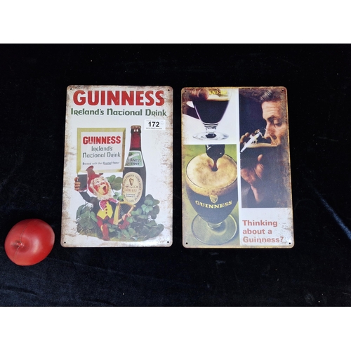 Two metal Guinness branded advertising wall plaques.
