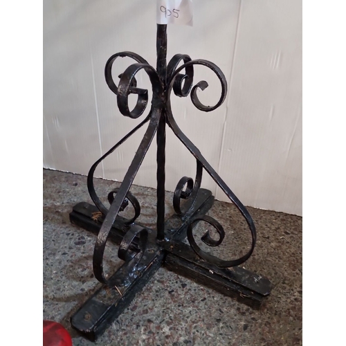 477 - Wrought iron plant stand features decorative scrollwork, square basket design, and tripod base.
