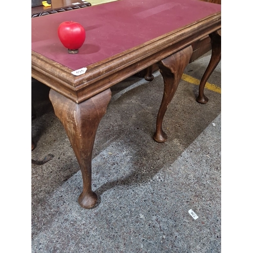494 - Queen Anne style table, mahogany with cabriole legs, red leather top, from the early 20th century.