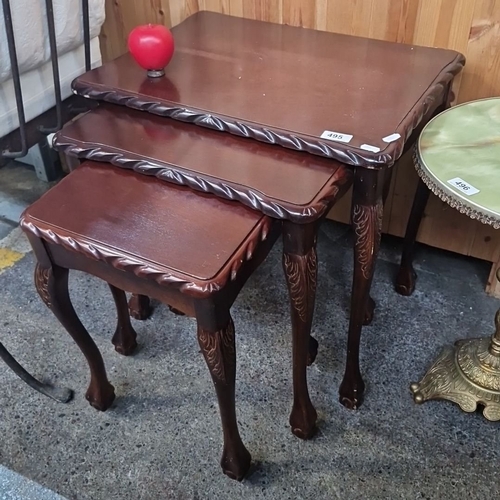 Set of three mahogany nesting tables with carved cabriole legs and rope-twist edge detailing.