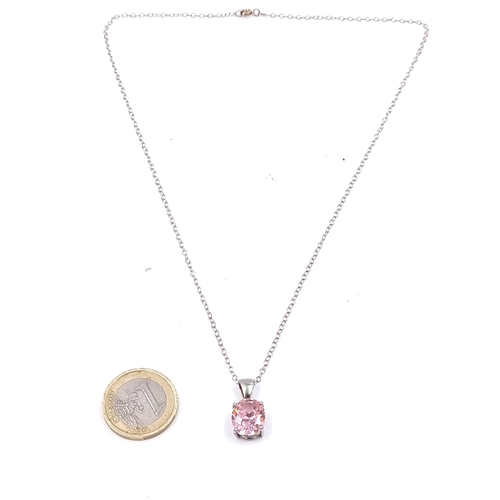 505 - A bright pink tourmaline pendant mounted in sterling silver with a sterling silver chain. Length 46c... 
