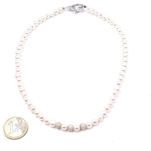 524 - A cultured pearl necklace with sterling silver T-bar clasp. Length 42cm. Weight 29.8 grams.