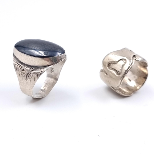 542 - Two sterling silver rings including a hematite example. Sizes N & T. Total weight 16.84 grams.