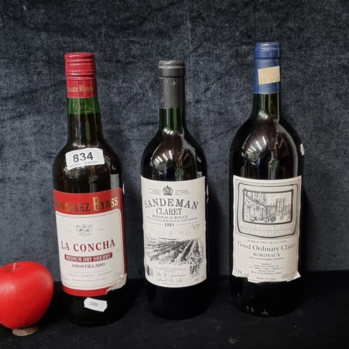 834 - Two bottles of claret red wine including a 1989 Sandeman Claret and a 1litre bottle of Berry Brother... 