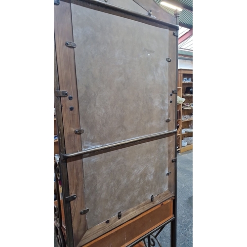 918 - A handsome hallstand with mirror, two drawers, and lower shelf. Features ornate carvings and wrought... 