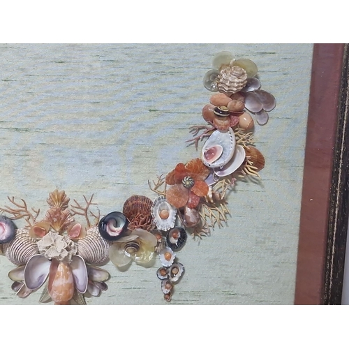 942 - An original shell art. Features a floral design with various shells and beads on green background. H... 
