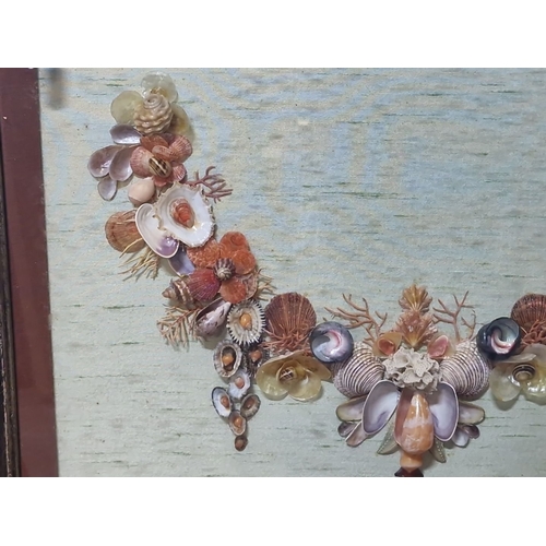 942 - An original shell art. Features a floral design with various shells and beads on green background. H... 