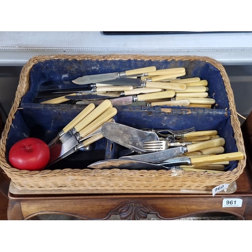 960 - Collection of vintage cutlery with bone handles in a woven basket. Includes knives, forks, and spoon... 