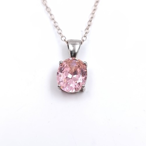 505 - A bright pink tourmaline pendant mounted in sterling silver with a sterling silver chain. Length 46c... 