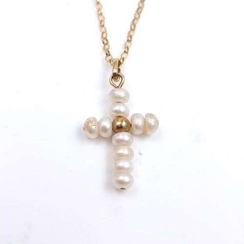 523 - Star Lot: A nine carat gold pearl pendant cross and chain. Length 46cm. Weight 1.168 grams. Boxed. T... 