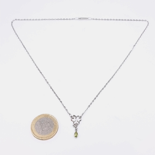Star Lot - A nine carat white gold necklace with a shamrock peridot pendant. Length - 40CM. Weight - 2.42g.