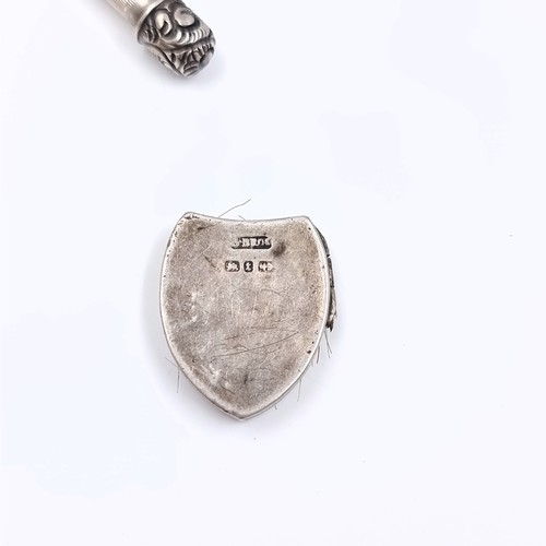 31 - A Victorian sterling silver mourning locket with no suspensions containing hair, hallmarked Birmingh... 
