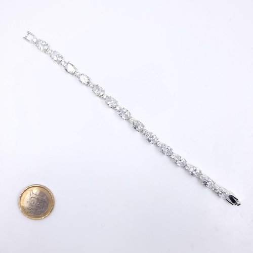 161 - A bright tennis style gemstone statement bracelet. Huge bright sparkly CZs Boxed.