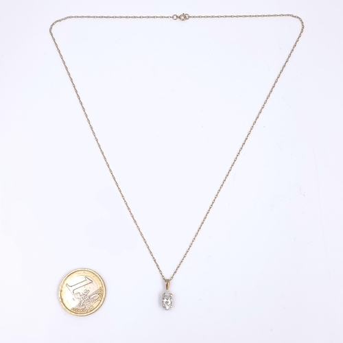 166 - Star Lot: A nine carat gold marquise gemstone pendant and chain. Length 44cm. Weight 1.54 grams.