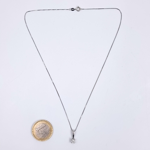167 - Star Lot: A nine carat white gold gemstone pendant and chain. Length 36cm. Weight 1.65 grams. Boxed.