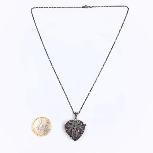 170 - A sterling silver 925 heart shaped locket pendant necklace with marcasite detailing. Length 44cm. We... 
