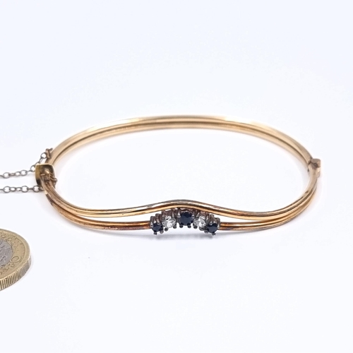 171 - An antique three sapphire and gemstone 1/20th 10 carat rolled gold twin band bangle bracelet set wit... 