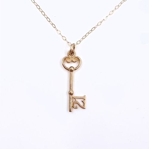 163 - Star Lot: A nine carat gold 375 key pendant (marked 21) and chain. Length 44cm. Weight 1.23 grams. B... 