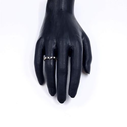 174 - Star Lot: A nine carat gold 375 gemstone wishbone ring. Size P. Weight 1.32 grams.