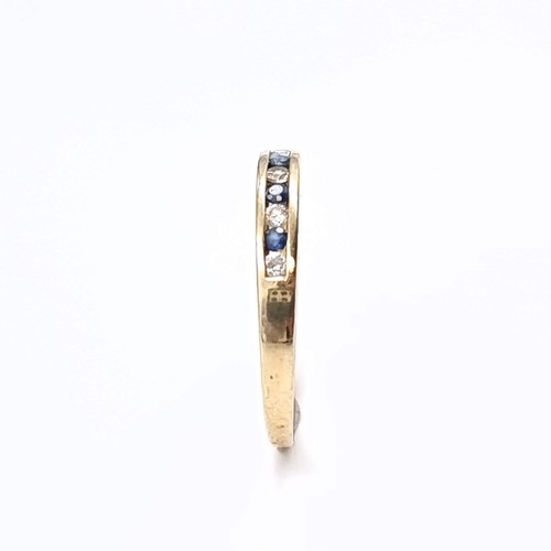 177 - Star Lot: A sapphire and gemstone half eternity ring set in nine carat gold 375. Size P. Weight 1.31... 