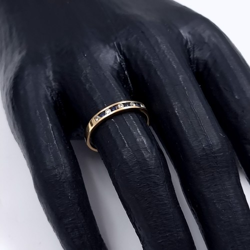 177 - Star Lot: A sapphire and gemstone half eternity ring set in nine carat gold 375. Size P. Weight 1.31... 