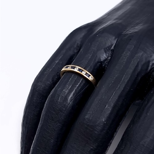 177 - Star Lot: A sapphire and gemstone half eternity ring set in nine carat gold 375. Size P. Weight 1.31... 